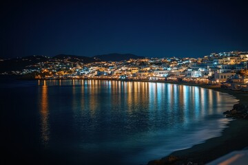 Fototapeta premium Nighttime view of Mykonos with shimmering lights and calm waters, Greece travel destination and tourist site Mykonos island at night
