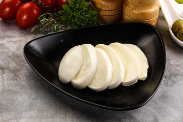 Organic mozzarella cheese slices in the plate