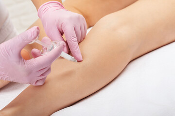 Aesthetic cosmetologist makes lipolytic injections to burn fat on the body of a woman. Female aesthetic cosmetology in a beauty salon.Cosmetology concept.