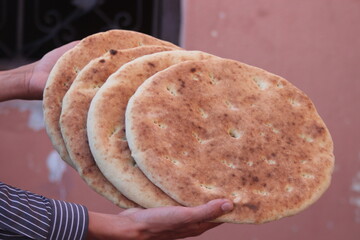 Hands holding traditional moroccan bread