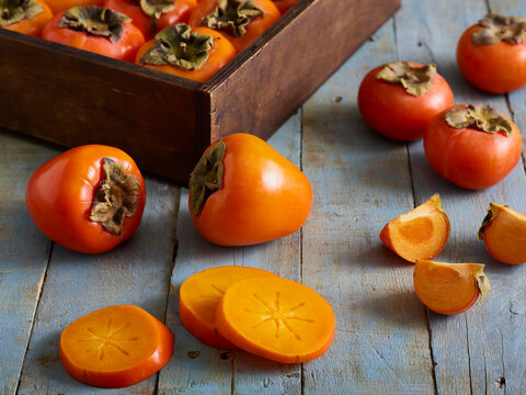Persimmons, sliced on cutting board