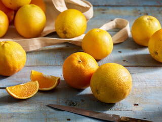 Fresh Valencia oranges sliced on cutting board