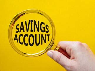 Savings Account symbol. Magnifying Glass with Concept word Savings Account. Businessman hand....