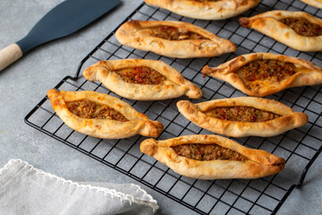 Dishes from traditional Turkish cuisine; Mini pita with minced meat - Turkish name; Kiymali mini pide