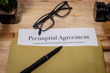 Prenuptial Agreement Document Resting on Wooden Desk – Legal Preparation Before Marriage