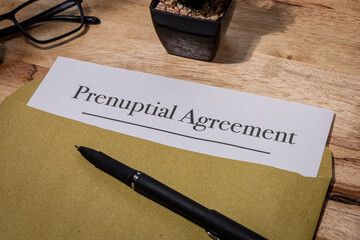 Prenuptial Agreement Document Resting on Wooden Desk – Legal Preparation Before Marriage