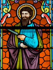 Fototapeta premium Stained glass (19th century) of St. Bartholomew the Apostle depicted with a knife. Catholic saint.