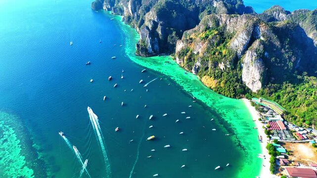 Aerial Tilt Up Scenic Shot Of Nautical Vessels On Maya Bay At Phi Phi Island, Drone Flying Forward During Sunny Day - Phi Phi Islands, Thailand