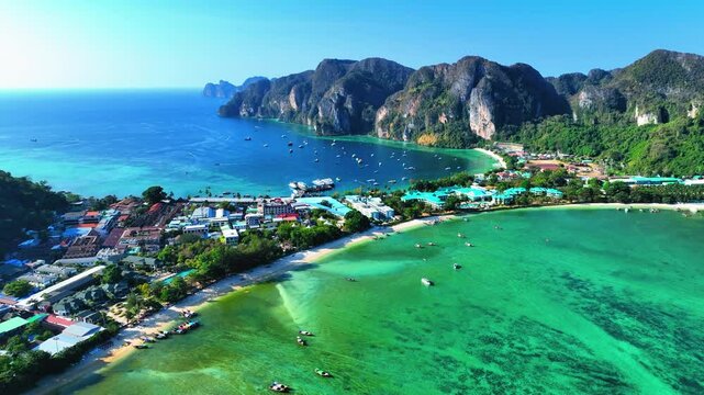 Aerial Forward Scenic Shot Of Resorts On Phi Phi Island, Drone Flying Forward Over Sea On Sunny Day - Phi Phi Islands, Thailand