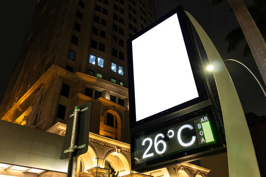 Billboard blank mock up on a digital street clock in the city of Sao Paulo. Use this photo day mockup for your outdoor design.