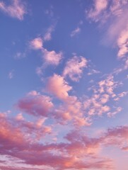 Fototapeta premium Beautiful pastel clouds in a serene sky during sunset, showcasing hues of pink, purple, and blue for tranquil nature and landscape photography