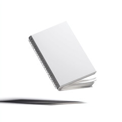 White notebook floats mid-air, offering blank cover for design or notes