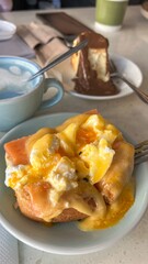 Delicious Eggs Benedict with Salmon and Chocolate Cheesecake on a Table, Food Photography