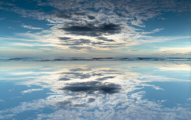 Serene Dawn Glass-like Ocean Reflection with Stunning Cloudscape