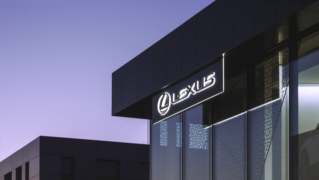 Poznan, Poland - March 28, 2025: Lexus logo on a dealership in picturesque sunset scenery.