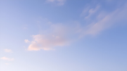 A soft pastel blue sky with clouds tinged in light lavender and pink shades, floating lazily across the calm expanse, evoking a sense of relaxation and calmness.