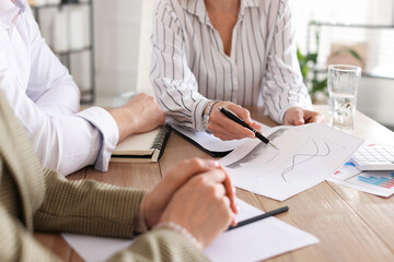 Couple having meeting with banker at desk in office, closeup
