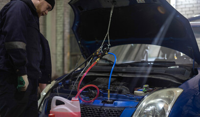 replacing antifreeze in a car, filling with coolant using a hose
