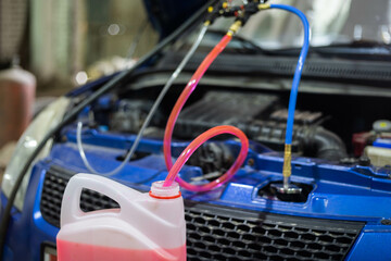 replacing antifreeze in a car, filling with coolant using a hose