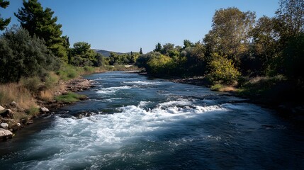Obraz premium Serene River Flowing Through Lush Green Landscape