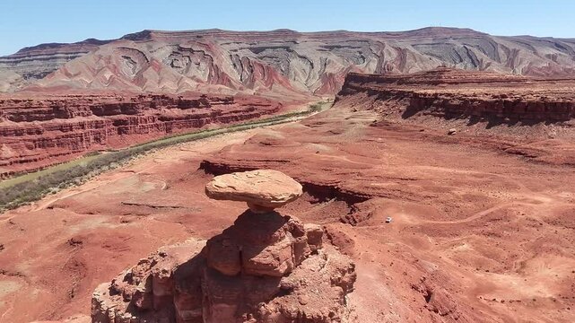 Aerial Flyover of Mexican Hat Rock Formation in Utah Desert