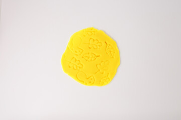 Forest scene imprinted in yellow modeling clay featuring leaf details, perfect for eco brands, children's books, classroom posters, STEAM projects, DIY lessons, seasonal campaigns.
