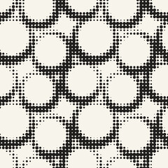 Vector seamless pattern. Monochrome stylish background. Rings in traditional halftone. Abstract texture from small dots.