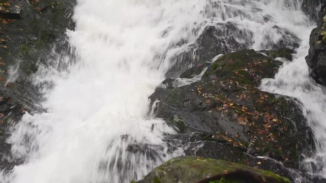 Majestic aerial footage showcasing Belye Mosty Waterfall in Karelia, Russia&rsquo;s tallest waterfall, cascading through vibrant fall foliage and rugged natural terrain.