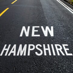 New hampshire road marking on freshly paved asphalt highway surface