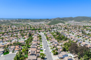 Aerial view of San Marcos neighborhood with houses and street during sunny day, South California,...