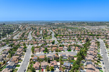 Aerial view of San Marcos neighborhood with houses and street during sunny day, South California,...