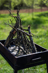 The old barbecue grill is set up in a country yard . Barbecue grill with smoke. Barbecue on the...