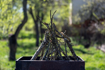 The old barbecue grill is set up in a country yard . Barbecue grill with smoke. Barbecue on the...