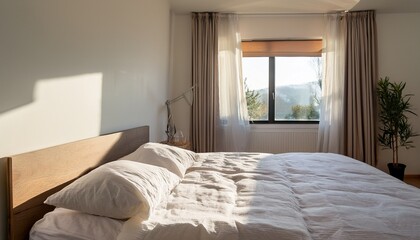 soft sunlight streams through the window onto an unmade bed with white linens in a minimalist room