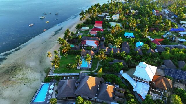Aerial Panning Beautiful Shot Of Houses On Island By Sea At Sunset - Siargao Island, Philippines