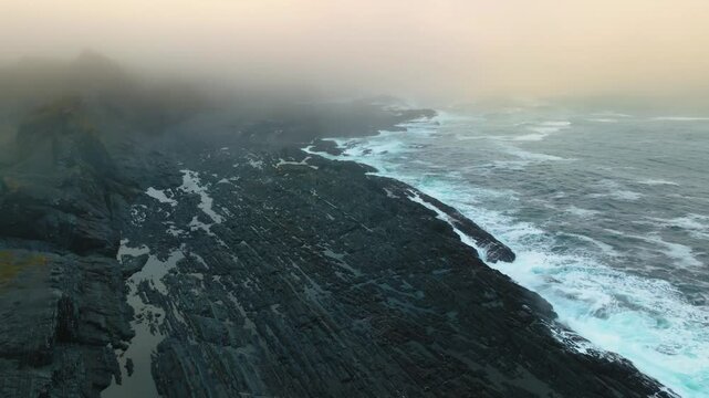 The footage captures dramatic ocean waves colliding with a rocky shore, highlighting the powerful natural forces of the vast saltwater ocean covering the majority of Earth's surface.