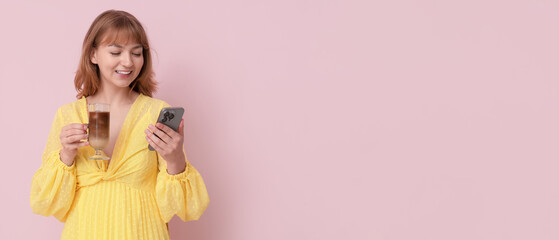 Happy young woman with glass of tasty iced latte and mobile phone on pink background