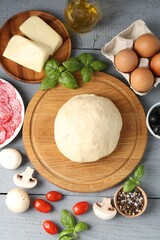 Making pizza. Different ingredients on gray wooden table, flat lay