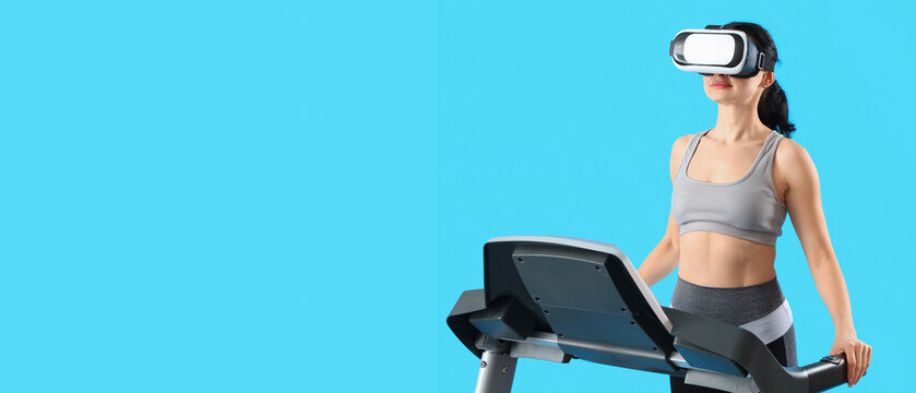 Beautiful woman in VR glasses training on treadmill against blue background