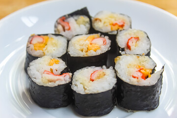 close up of several pieces of sushi on a plate