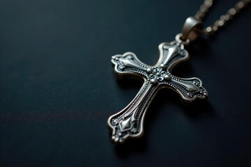 Silver cross pendant, ornate detail, dark background, symbol, celebration, silver