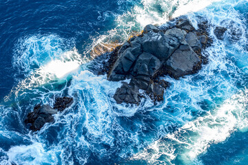 The view from Tasmania's Cape Hauy on the Three Capes Track of swell crashing against the rocks