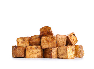 Pieces of fried tofu cheese with soy sauce on white background