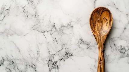 Wooden spoon on marble background culinary kitchenware photography