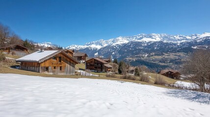 Picturesque Alpine Village with Wooden Chalets Surrounded by Snow-Capped Mountains and Blue Sky