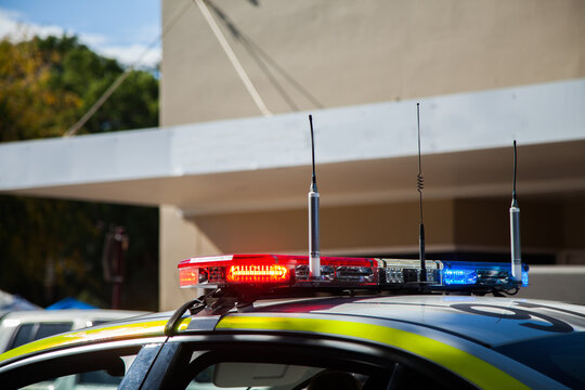 Police car lights flashing red and blue on the roof