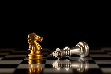 The golden chess king leads the silver chess pieces on the chessboard, business, success,...