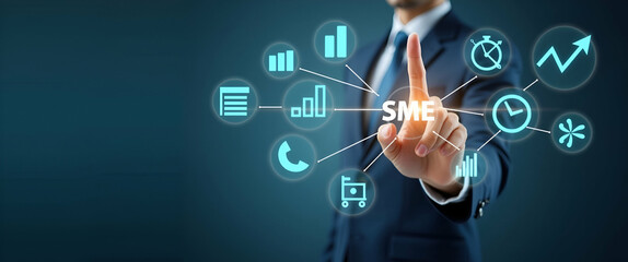 Fototapeta premium Hand pointing at holographic SME business growth icons with various business related symbols representing growth strategy success of small and medium sized enterprises in empty space concept as Hand p