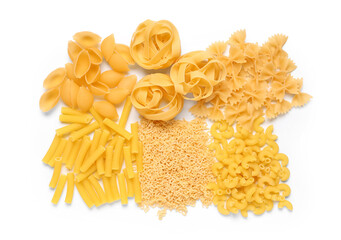 Heaps of different raw pasta on white background