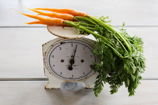 Bunch of carrots on a vintage set of scales
